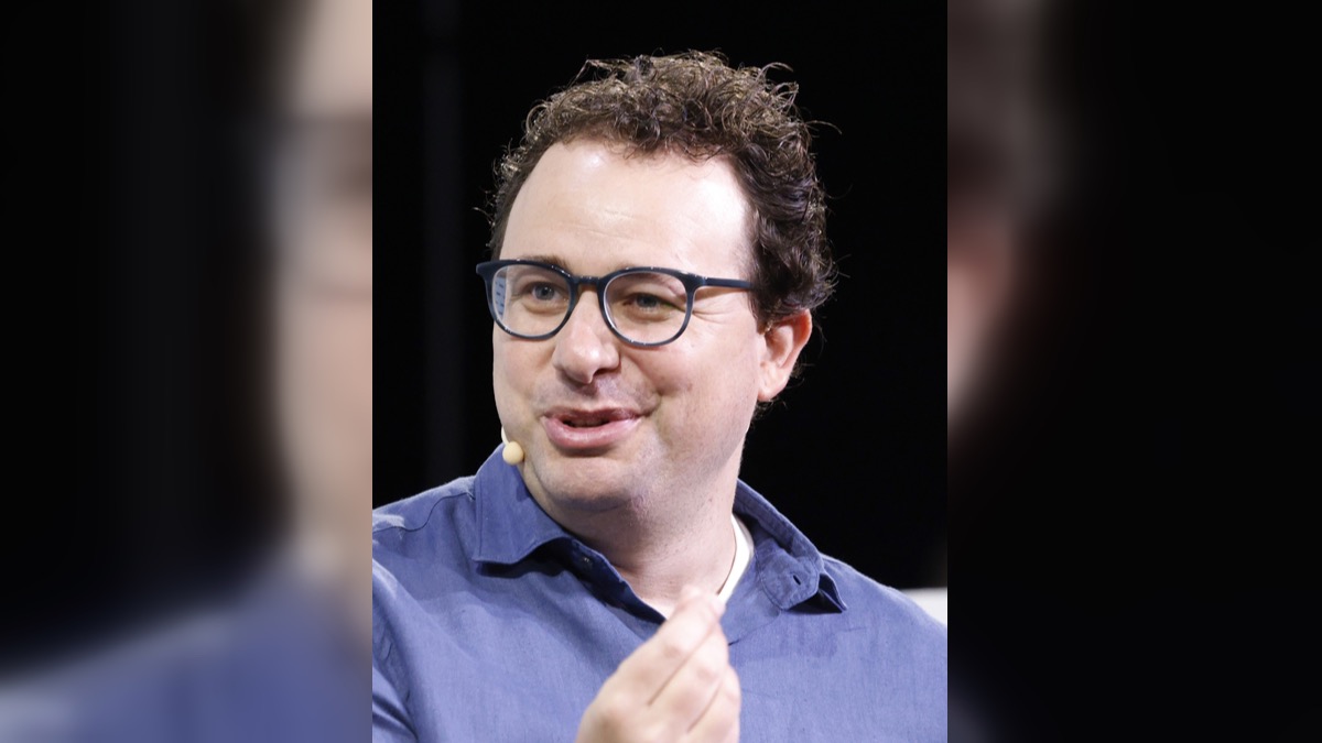 Dario Amodei speaking onstage at TechCrunch Disrupt 2023 in a 16:9 editorial social-card crop.