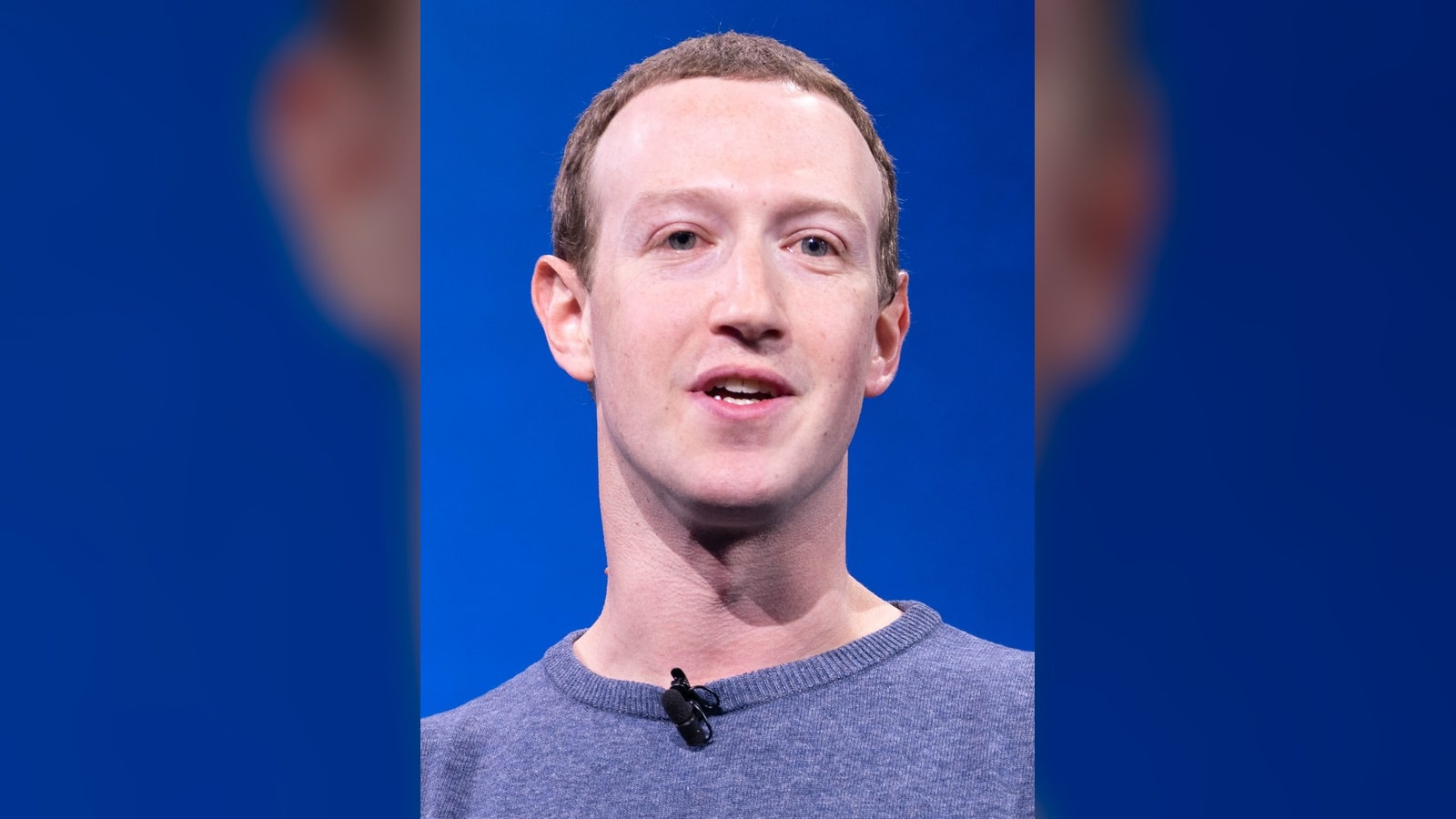 Mark Zuckerberg speaking at Facebook's F8 developer conference in front of a blue stage background.