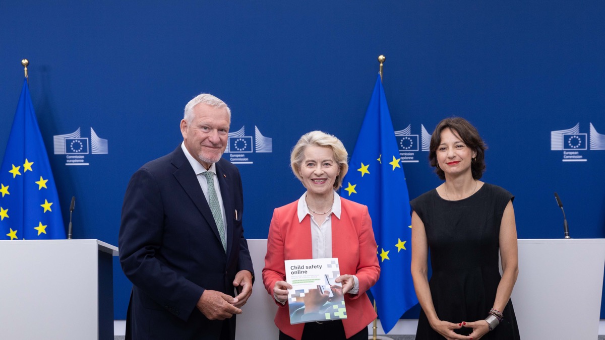 European Commission President Ursula von der Leyen holds the Child Safety Online report between panel co-chairs Jörg Fegert and Maria Melchior in Brussels.