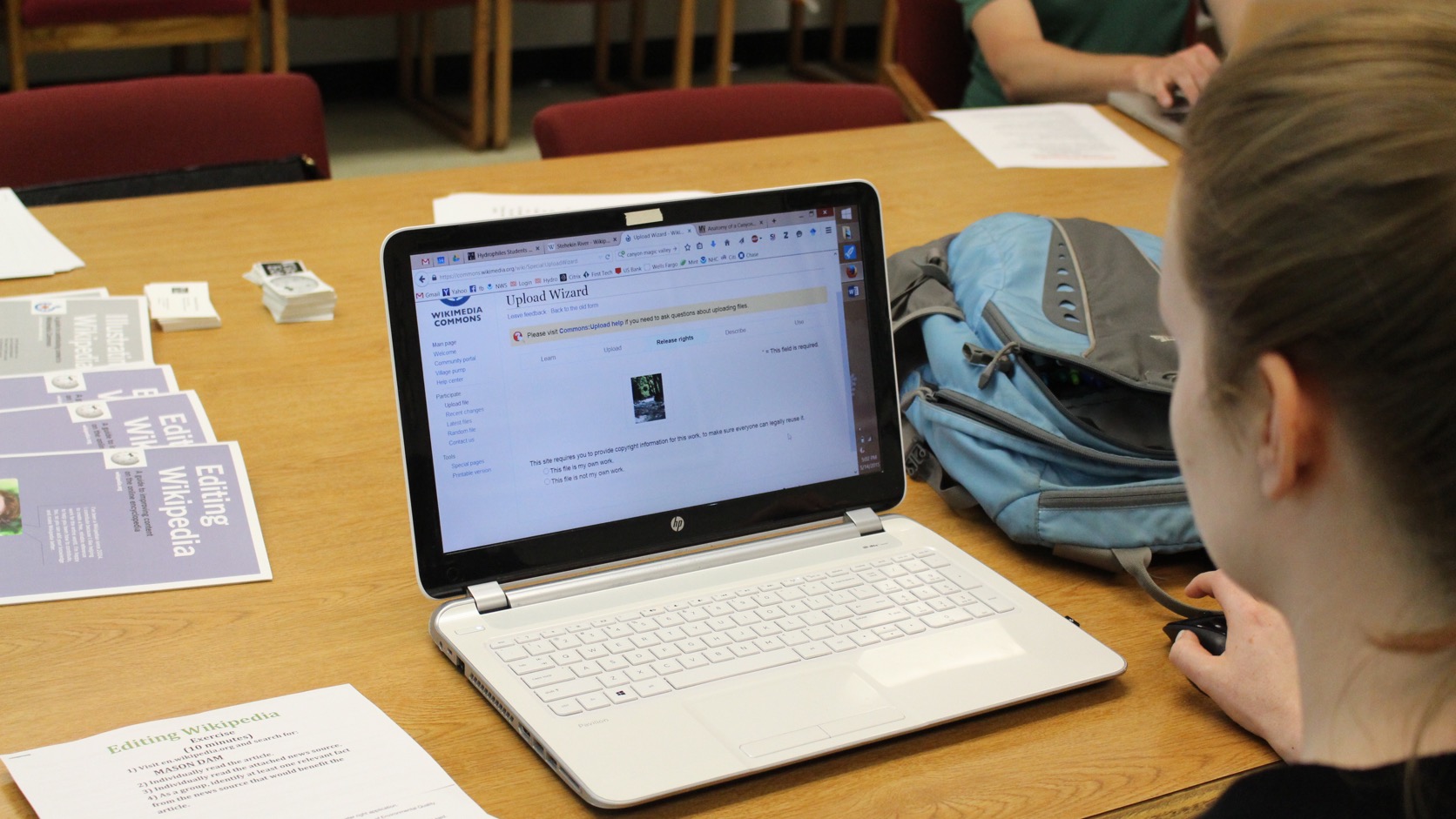 A graduate student works on a laptop during a digital publishing workshop.